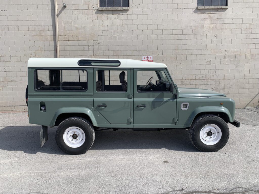 Right side profile of The Nomad with chequer plate sills and white Wolf wheels