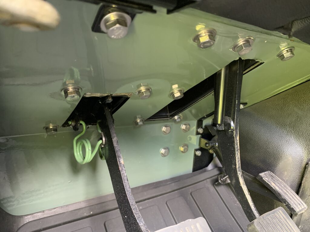 Pedal box of The Nomad with restored, freshly plated original Land Rover hardware