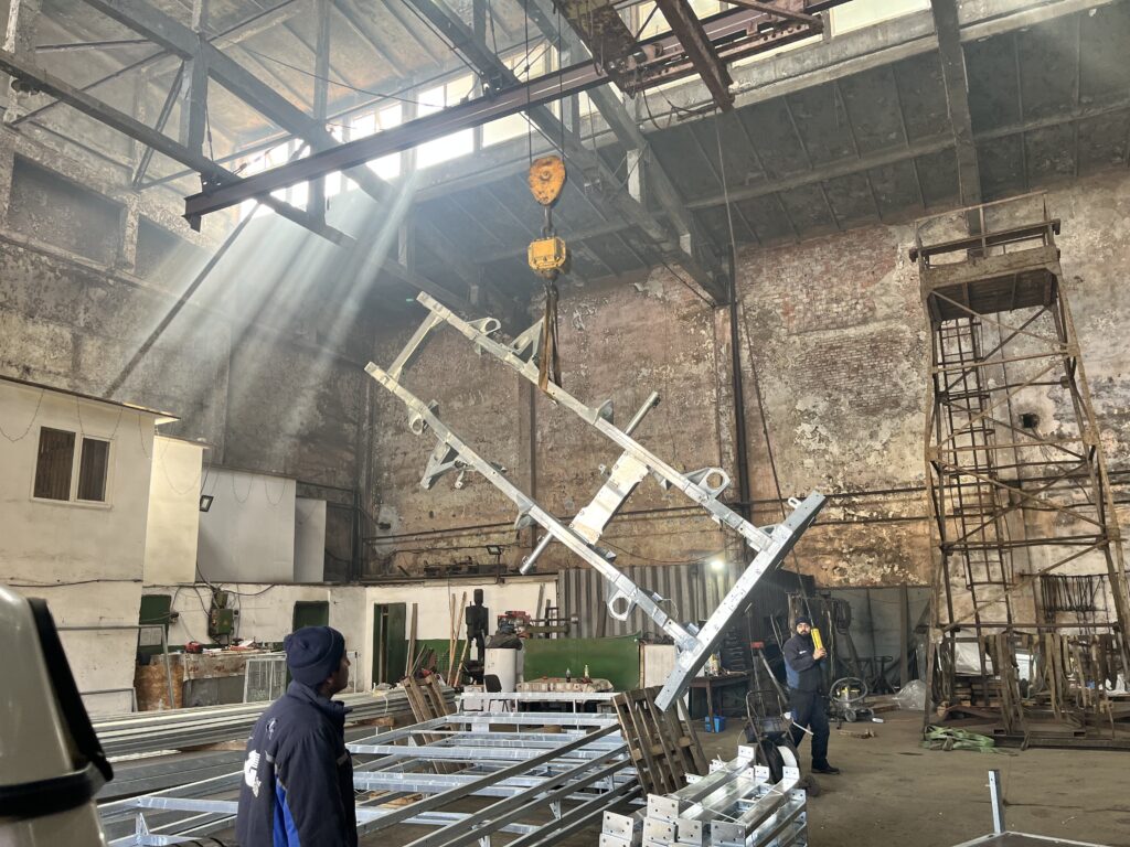 The Ninety's original Land Rover chassis being lifted at the galvanizing works