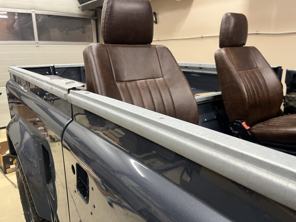 Distressed brown leather seats and galvanized tub cappings in the Ninety