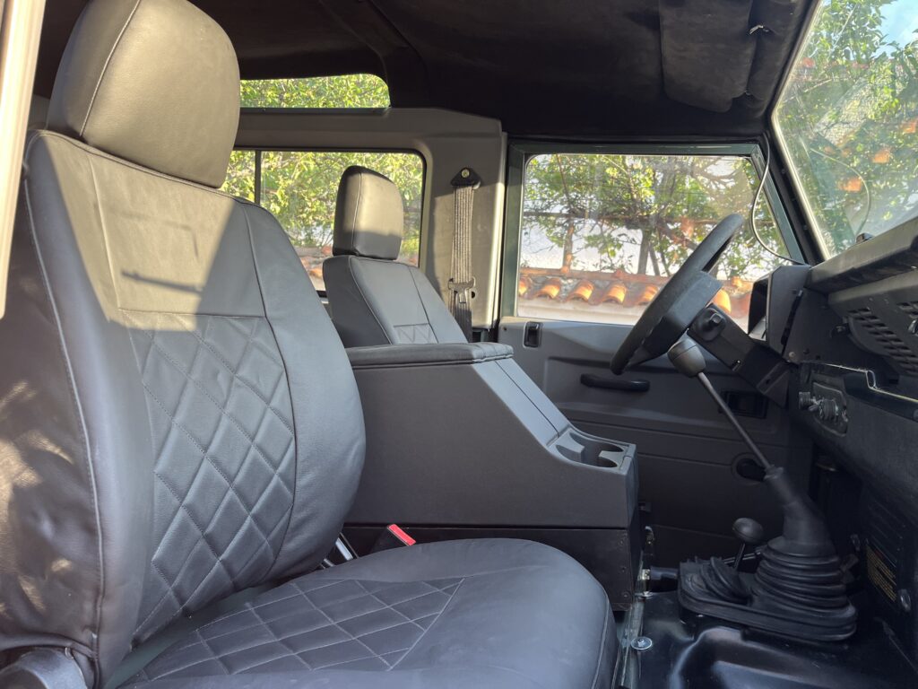 Black diamond-stitched leather front seats and matching cubby in The Evergreen