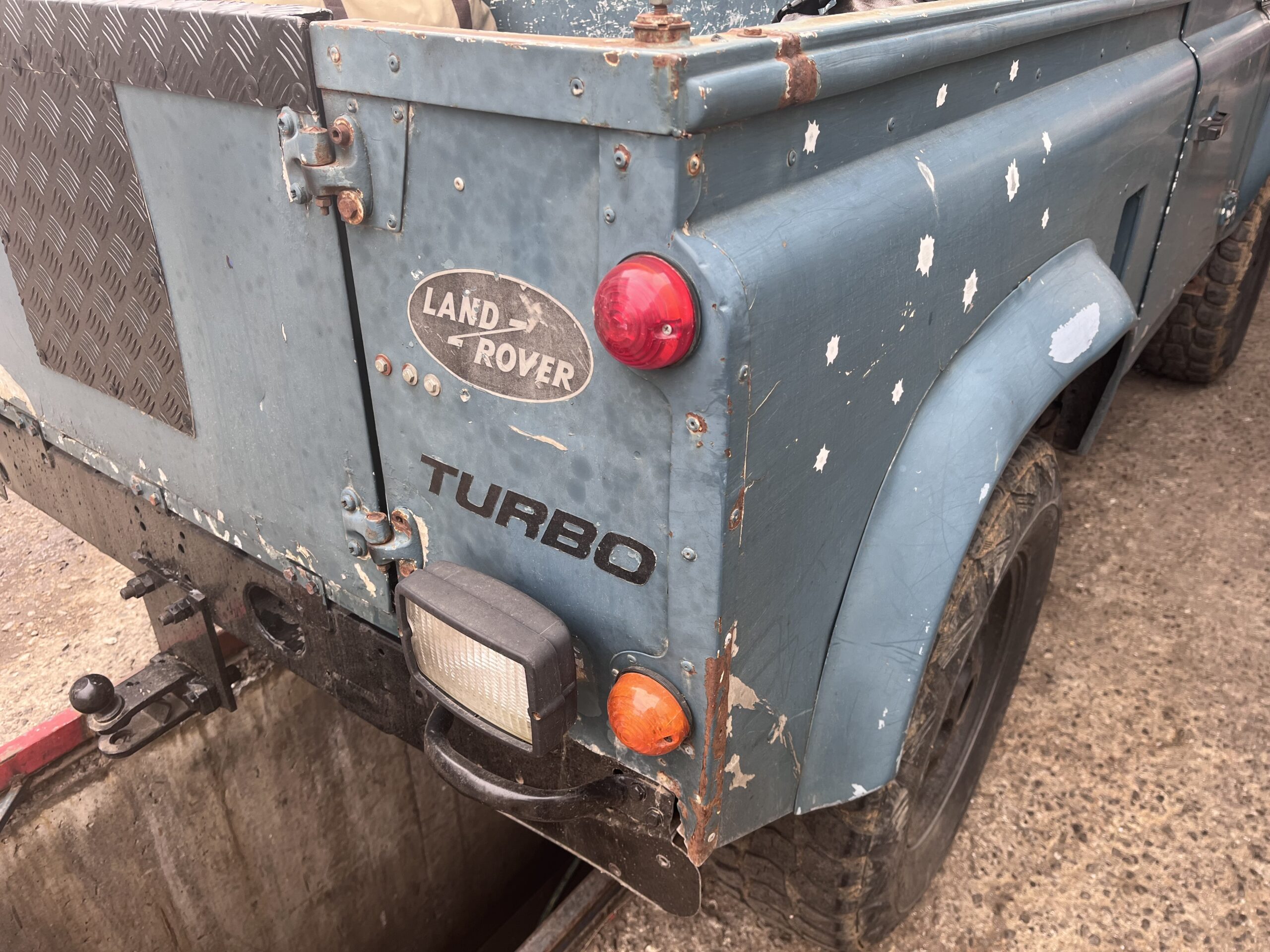 Barry's crushed rear tub corner, dotted with fake bullet-hole stickers