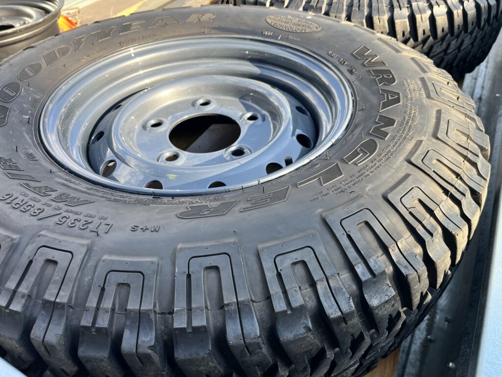 A Wolf steel wheel painted in Polymetal Grey to match the Ninety's body, with a new tyre