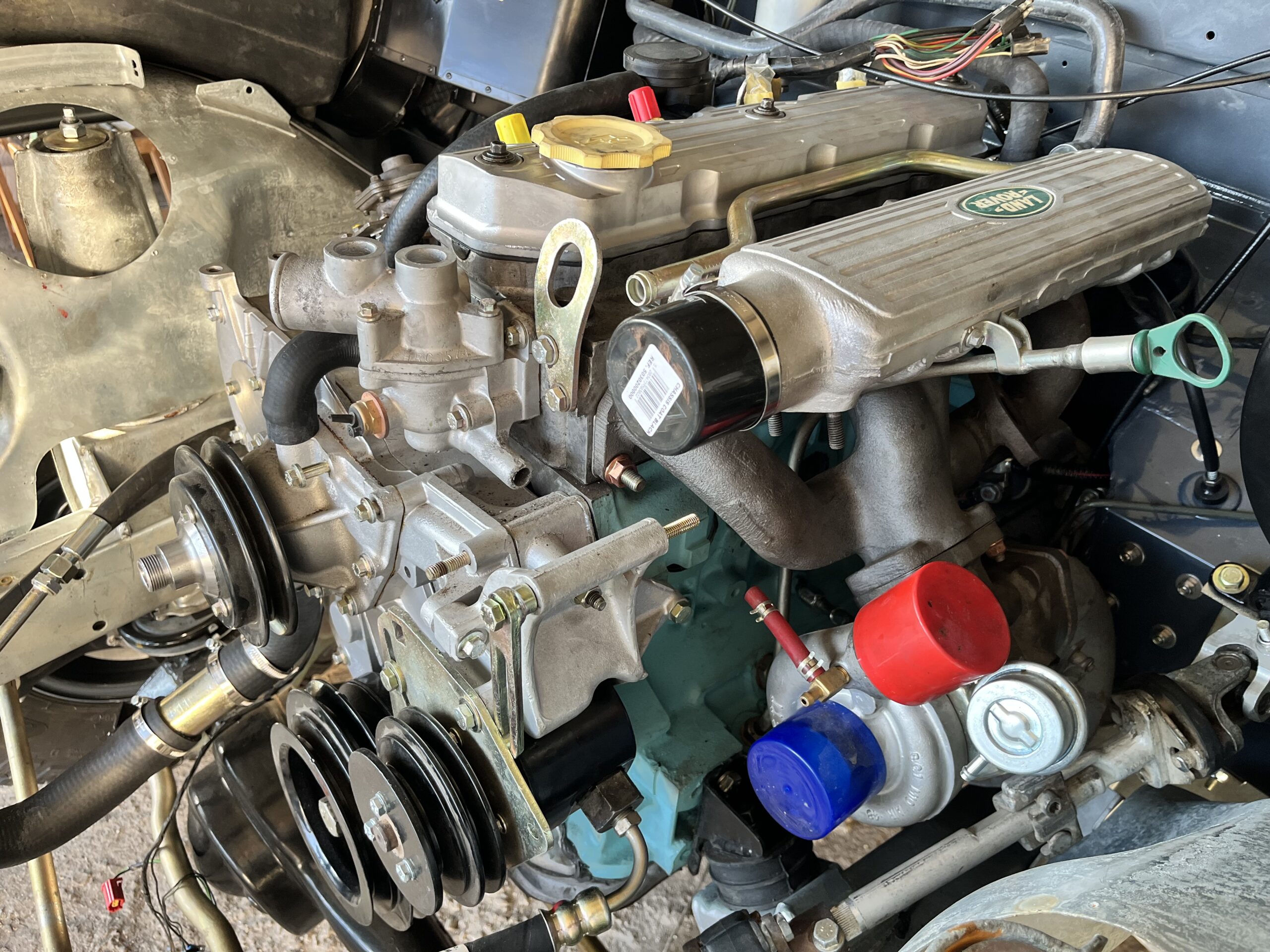 The rebuilt 200Tdi installed in the Ninety, its duck egg green block and blasted castings visible